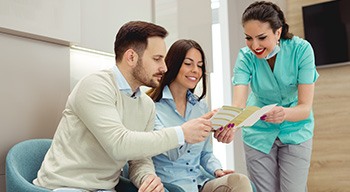 Patients reviewing dental insurance with a dentist