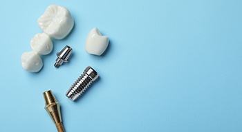 assorted dental bridge parts against a blue background