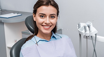 a patient smiling while visiting her dentist