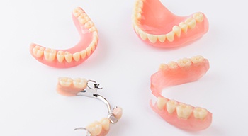 Bird’s eye view of full and partial dentures on white background