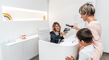 Female patient making a payment at dentist’s office