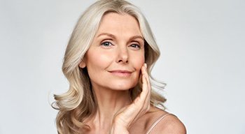 a woman touching her jaw with comfort and relief